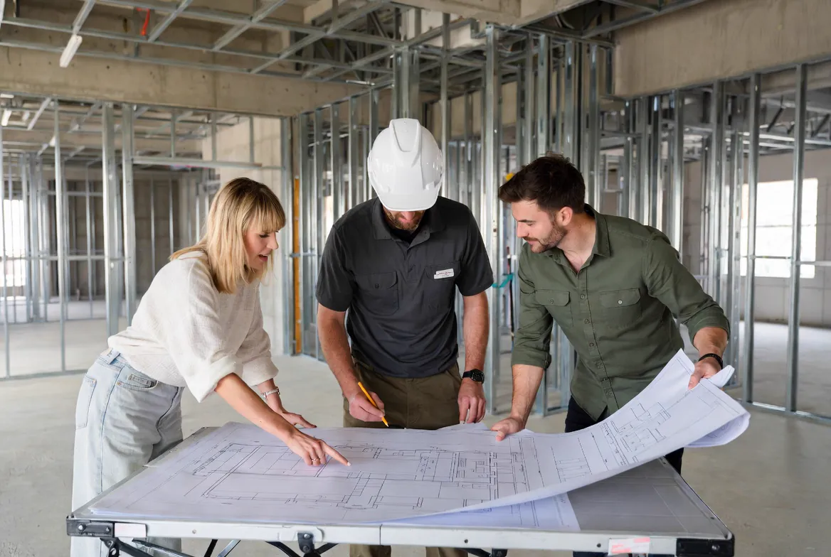 Construction design and planning phase with architectural drawings, blueprints, and cost breakdowns